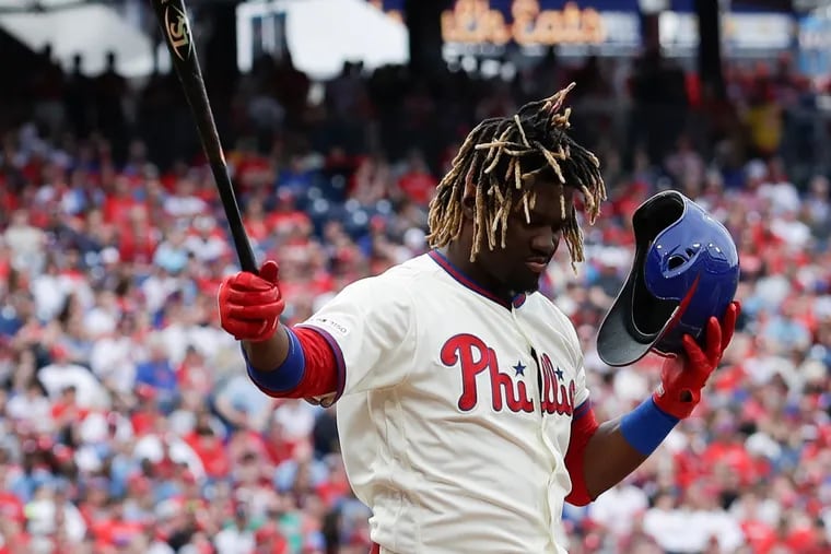 Phillies Odubel Herrera catches his helmet batting against the Atlanta Braves on Saturday, March 30, 2019 in Philadelphia.
