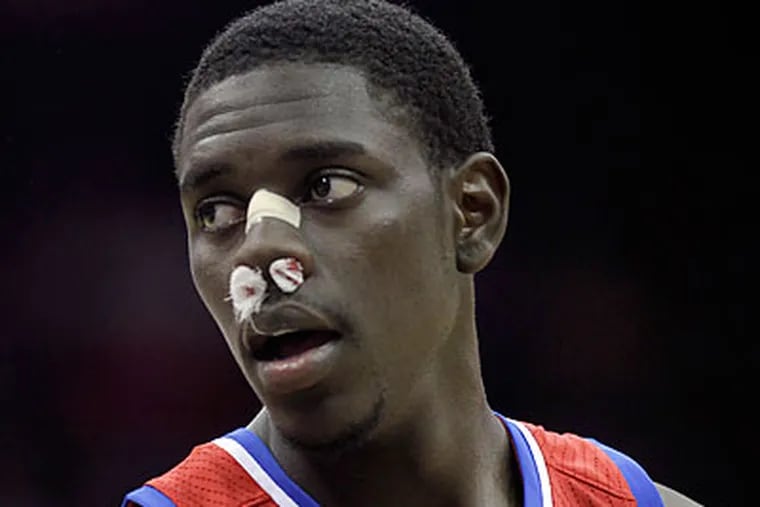 Despite suffering an injury, Jrue Holiday finished with 15 points and four assists against the Nets. (Julio Cortez/AP)