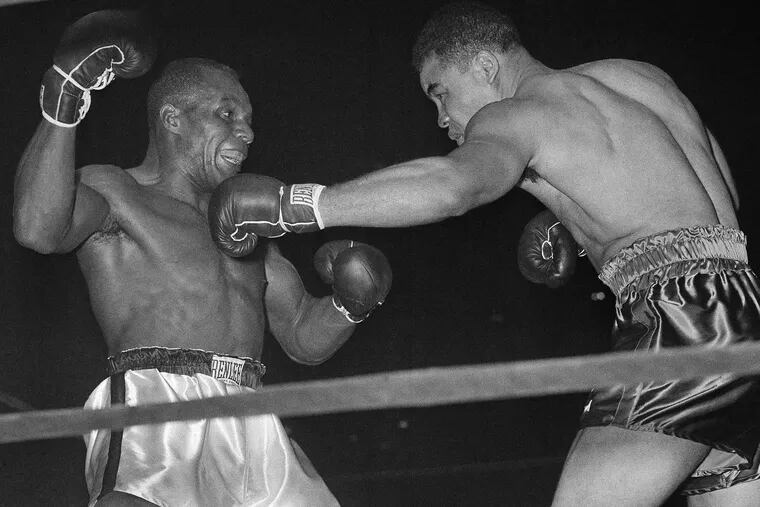** FILE ** Heavyweight champion Joe Louis, right, bounces a left off the chin of challenger Jersey Joe Walcott in the fourth round of their scheduled 15-round title fight at Madison Square Garden in New York, in this Dec. 5, 1947 file photo.