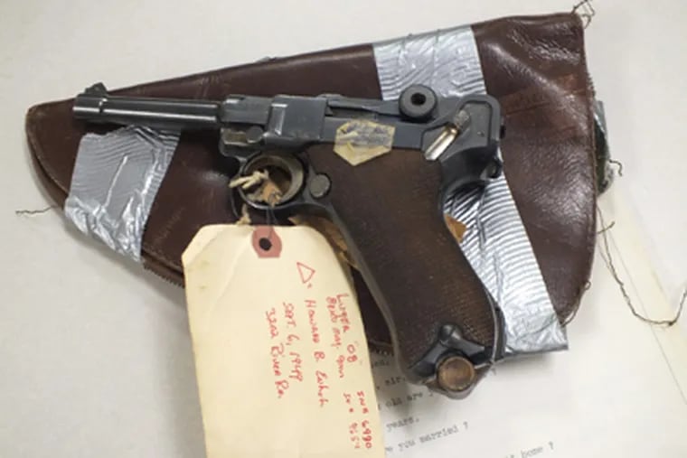 The 9 mm Luger Howard Unruh used to kill 13 people in 1949 is shown 2/24/12 on top of the original transcript of his confession made shortly after the massacre.
