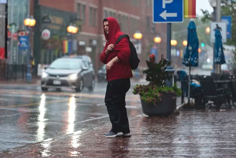 A man walks in the rain on Main street in Moncton, N.B. as a result of hurricane Dorian as a result of hurricane Dorian pounding the Atlantic Provinces with heavy rain and winds on Saturday September 7, 2019. THE CANADIAN PRESS/Marc Grandmaison