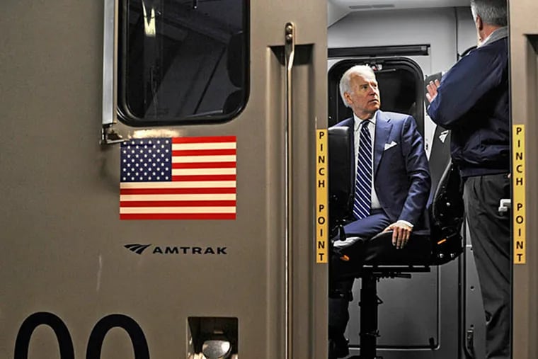 Vice President Joe Biden sits at the controls of a new Cities Sprinter locomotive at 30th Street Station. (Tom Gralish/Staff)