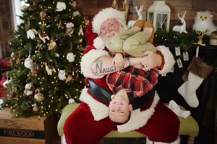 Santa Scott hangs Jason Maury, 6, of Bensalem upside down – with parents' permission – in one of his sillier poses.