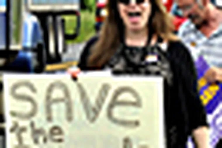 Sarah Thatcher, left, of Bethlehem, Pa., President of Saucon Valley Education Association, joins a protest march on  Wednesday in Lower Saucon Township, Pa.  Protesters statewide took to the streets on Wednesday to protest education cuts that they say have decimated school districts across Pennsylvania, and called for lawmakers to reject further reductions proposed for next year by Gov. Corbett. LISA MASSEY / The Express-Times