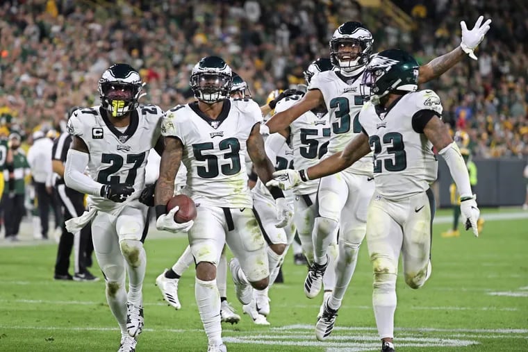 The Eagles defense with Nigel Bradham, center with the ball, celebrate his interception that sealed the victory over the Packers.