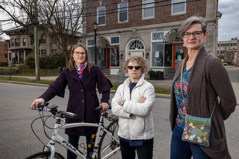 From left are Melanie Rodbart, Alison Manaker and Julie Ellis. They are among residents of Swarthmore opposed to a plan to build a five-story, 30-unit condo building along Park Avenue in the center of Swarthmore business district.