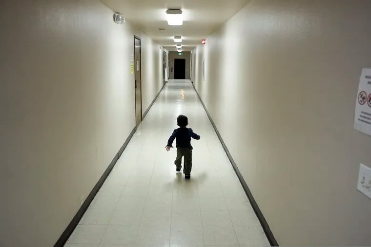 An asylum-seeking boy from Central America runs down a hallway after arriving from an immigration detention center to a shelter in San Diego in December 2018.