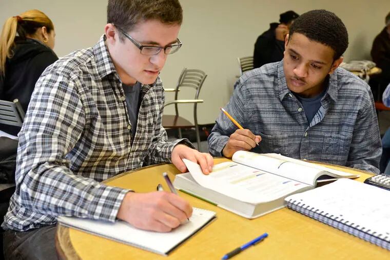 At Burlington County College , Ryan Snell (left) tutors freshman Tomaz Powell as a volunteer. Snell, who was homeschooled, has applied to Penn and other prestigious colleges. TOM GRALISH / Staff Photographer
