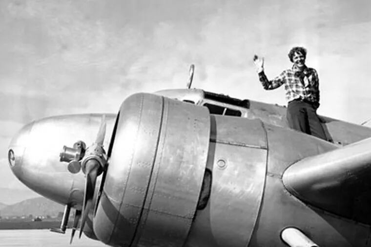 FILE - In a March 10, 1937 file photo American aviatrix Amelia Earhart waves from the Electra before taking off from Los Angeles, Ca., on March 10, 1937.  Earhart is flying to Oakland, Ca., where she and her crew will begin their round-the-world flight to Howland Island on March 18.  (AP Photo, file)