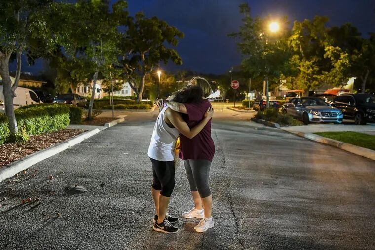 Hannah Karcinell (left), 18, a student at Marjory Stoneman Douglas High School in Parkland, Fla., hugs her mother, Jodi, after attending a rally against assault weapons.