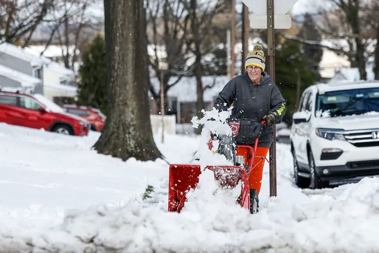 Jennifer Leap of Skippack uses a snow blower on Columbia Avenue after Tuesday's snowfall. More evidently is on the way.