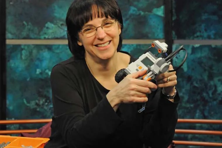 Jennifer Kay, a Rowan professor who has received Google grants for a series of workshops teaching high school teachers about robotics, with her Lego robots at Rowan on Jan. 2, 2014 .  ( APRIL SAUL  / Staff )