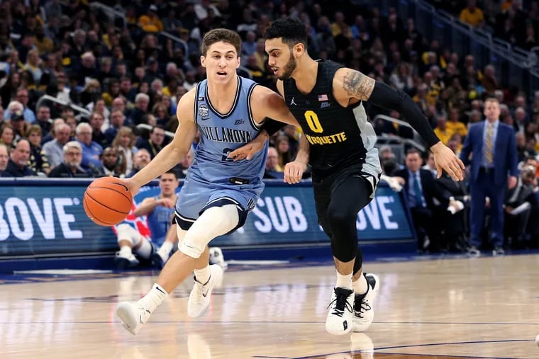 Villanova guard Collin Gillespie trying to dribble past Markus Howard of Marquette during a Big East game Saturday. The Big East has six teams in ESPN bracketologist Joe Lunardi's latest projections.