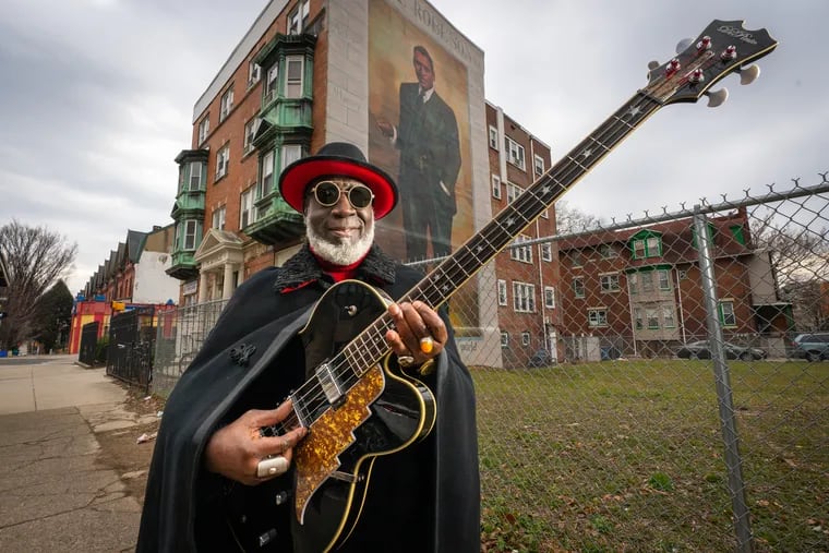 Jamaaladeen Tacuma, a jazz-funk bass player and longtime Philadelphia musician, is shown here on Chestnut Street between 45th and 46th Streets, in front of the Paul Robeson mural, a Mural Arts Philadelphia painting, which was painted by Mural Arts Philadelphia artist Ernel Martinez, in Philadelphia, Tuesday, January 25, 2022. Jamaaladeen Tacuma's upcoming tribute concerts to Paul Robeson begin on Feb. 2, 2022.