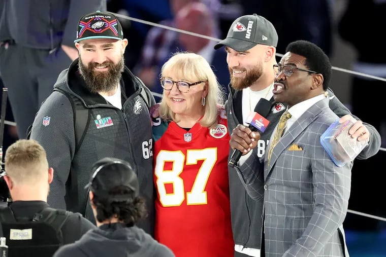 Philadelphia Eagles center Jason Kelce (left) poses with his mom, Donna (center) and Kansas City Chiefs tight end Travis Kelce (second from right) during the Super Bowl LVII Opening Night event at the Footprint Center on Monday, Feb. 06, 2023, in Phoenix, Ariz. .