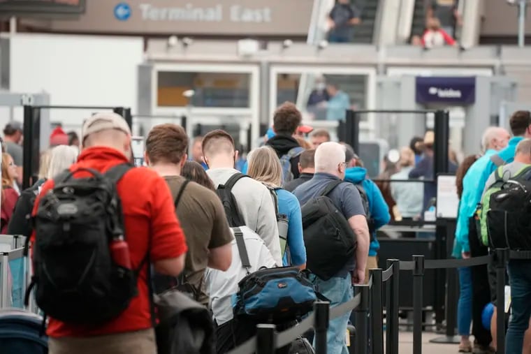 Travelers queued up at the north security checkpoint in the main terminal of Denver International Airport on May 26.