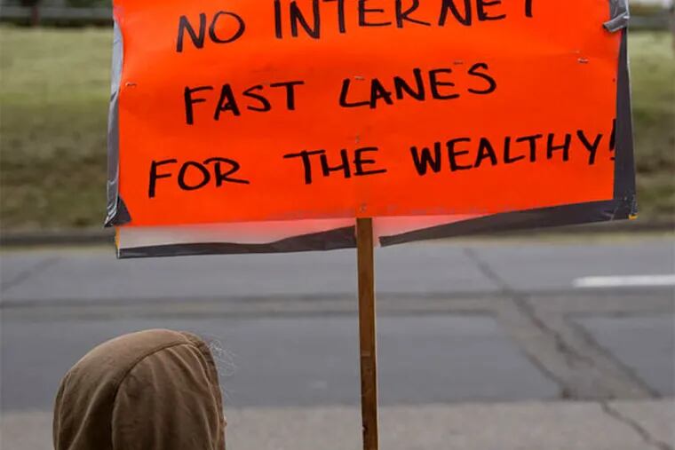 A demonstrator protests in favor of Internet neutrality outside the FCC headquarters in Washington. (ANDREW HARRER / Bloomberg News)