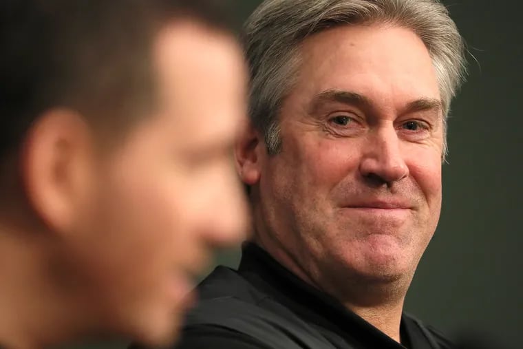 Eagles coach Doug Pederson, right, smiles as executive vice president of football operations Howie Roseman speaks during a news conference at the team's practice facility Tuesday.