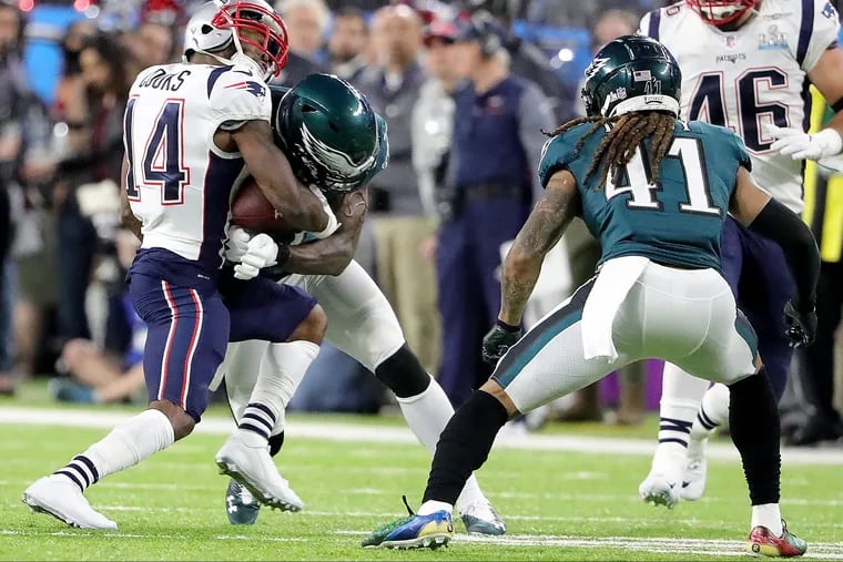 Eagles safety Malcolm Jenkins knocks New England's Brandin Cooks out of the game with a jarring hit. DAVID MAIALETTI / Staff Photographer