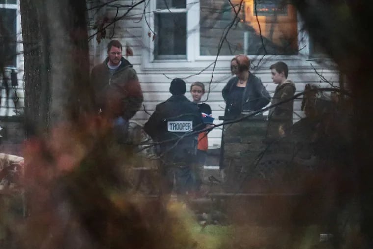 Police with neighbors near the scene where the body of Bradley William Stone, 35, of Pennsburg, Pa., a suspect in six shooting deaths in Montgomery County, was found in the woods on Tuesday, December 16, 2014.   (  Steven M. Falk / Staff Photographer )