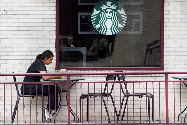 An unidentified woman seats outside at the Starbucks in Bala Cynwyd, Pa. Tuesday, May 29, 2018. After 2 scandals rocked the corporation, Philadelphians have had mixed reactions to the transgressions, and the company's attempts to heal public wounds.