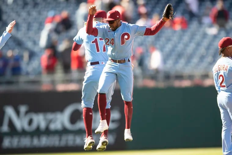 Philadelphia Phillies' Roman Quinn, right, and Rhys Hoskins celebrate after a baseball game against the Colorado Rockies, Thursday, April 28, 2022, in Philadelphia.