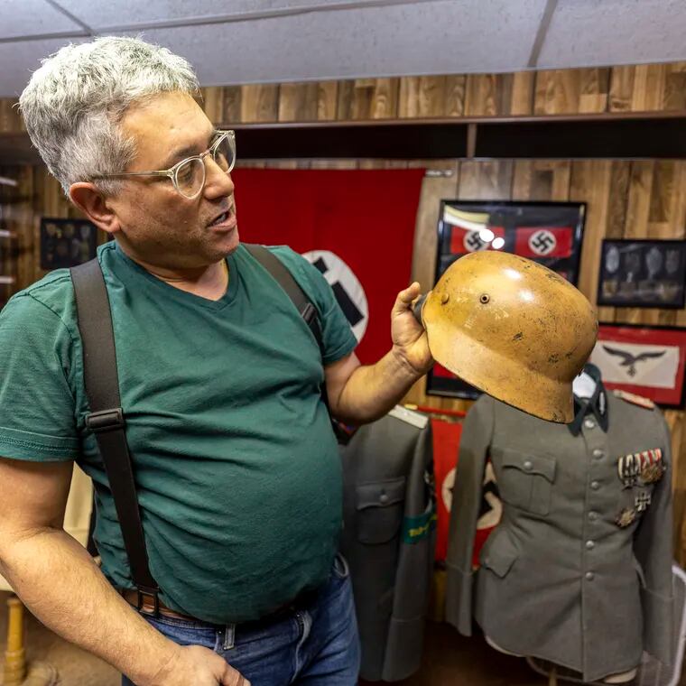 David Tabby shows one of his late father's favorite items, a desert camo Model M35 Stahlhelm combat helmet that German soldiers wore in North Africa with the Afrika Corps. The family is Jewish, and not direct descendants of Holocaust survivors.