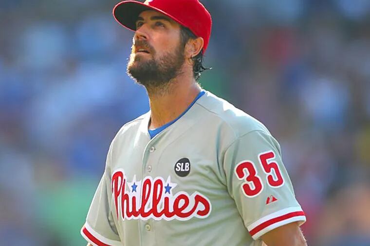 Philadelphia Phillies starting pitcher Cole Hamels (35) walks off the field after the eighth inning against the Chicago Cubs at Wrigley Field.