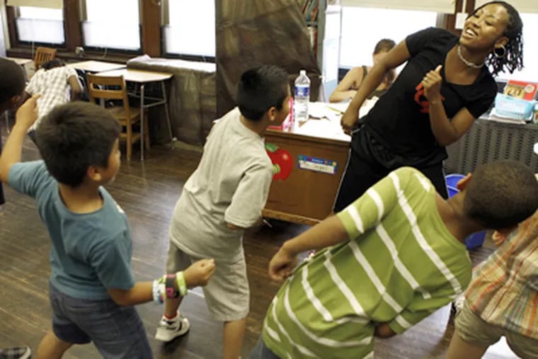 Dinita Askew teaches a dance class on the second day of summer school last week at Andrew Jackson Elementary School in Philadelphia.  (Laurence Kesterson / Staff Photographer)