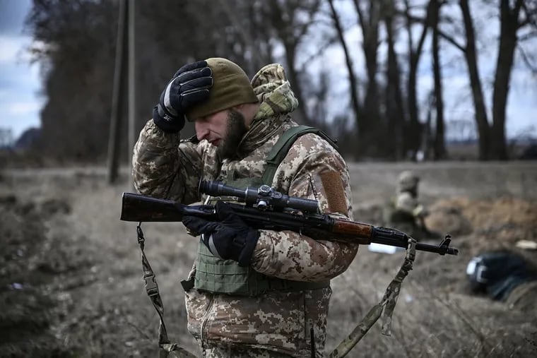 A Ukrainian serviceman holds a weapon near a front line, east of Kyiv, on March 9, 2022.