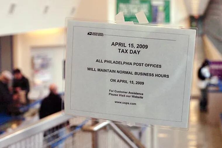 A sign taped to an entrance to Philadelphia's main post office, 30th and Chestnut Streets, informs customers that all Philadelphia post offices will maintain normal business hours on April 15th - Tax Day.  The counter at the main post office is open til 9 p.m., with automated service available 24 hours a day.