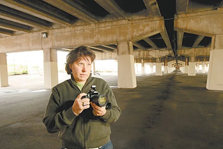 For 10 years, photographer Zoe Strauss has been holding an annual free photo exhibition in the shadowy realm below I-95 at Front and Mifflin. (Michael Bryant / Staff Photographer)