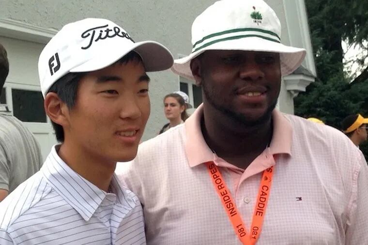 Amateur Michael Kim, left, with caddie Temple LaRue, 30, who has been at Merion for 16 years.