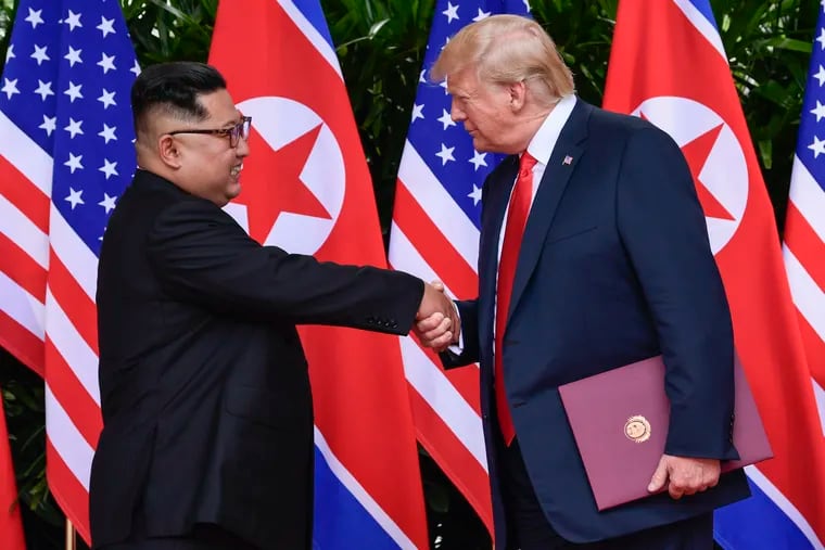 North Korea leader Kim Jong Un, left, and U.S. President Donald Trump shake hands at the conclusion of their meetings at the Capella resort on Sentosa Island in Singapore.
