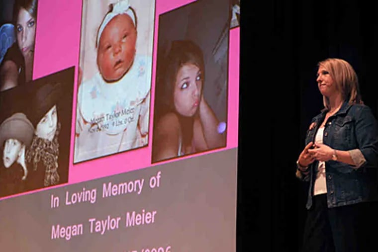 A photo tribute to Megan Meier, a victim of cyberbullying who hanged herself, was on the screen while her mother, Tina, spoke at a Haverford High School assembly.