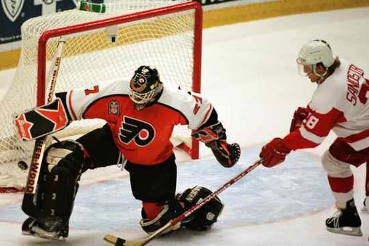 Flyers goalie Ron Hextall, who led the Flyers to the Stanley Cup finals 10 years earlier, kick-saves a shot by Detroit's Tomas Sandstrom in the 1997 finals. The Flyers were swept in four games.