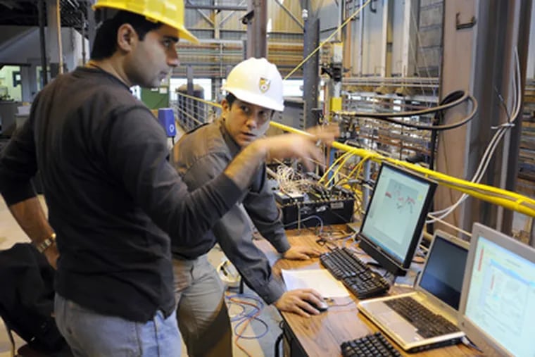 Lehigh University Department of Civil and Environmental Engineering
associate chair Clay Naito (right) and grad student Payam Piran (left) look over test readings in the lab at Lehigh's Center for Advanced Technology for Large Structural Systems (ATLSS). (Tom Gralish / Staff Photographer)