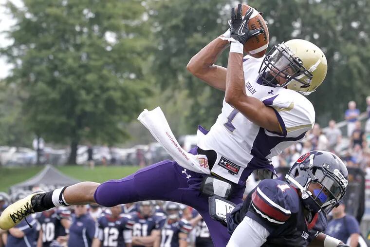 Roman Catholic's Will Fuller catches a touchdown pass over Cardinal O'Hara's Damiere Shaw in September 2011.