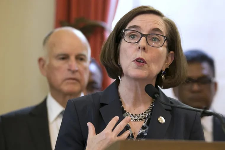 Oregon Gov. Kate Brown talks about climate change at a news conference held by California Gov. Jerry Brown on June 13 in Sacramento.