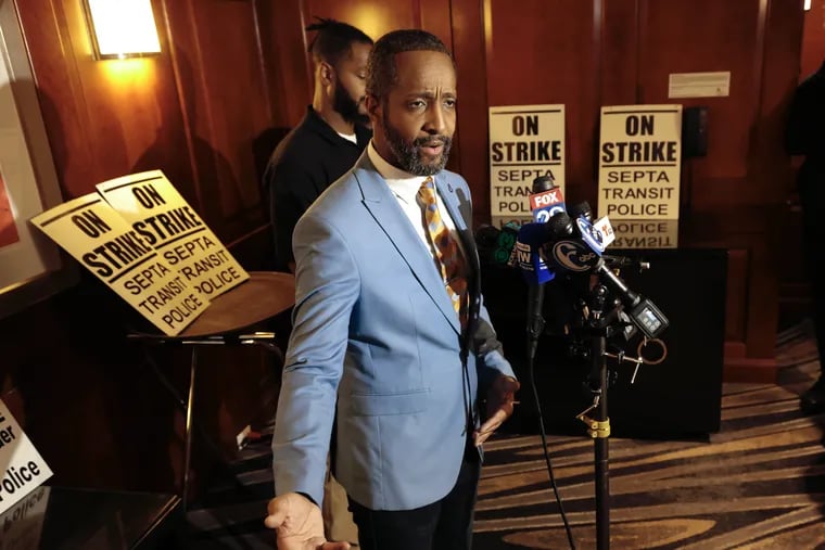 Fraternal Order of Transit Police FOP Lodge 109 Vice President Troy Parham announces that SEPTA transit police are on strike as FOTP president Omari Bervine stands by during a press conference at the Marriott Hotel in Philadelphia on Wednesday, December 13, 2023.