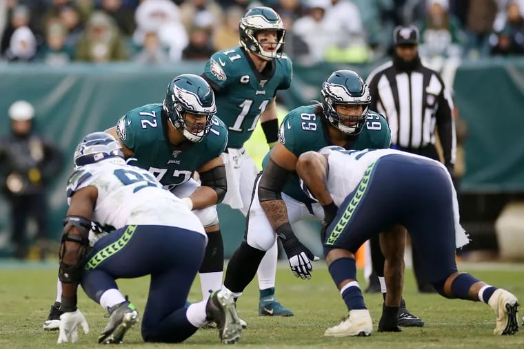 Eagles tackle Halapoulivaati Vaitai (72) and guard Matt Pryor (69) line up in front of quarterback Carson Wentz (11) against the Seahawks on Nov. 24. The Eagles lost, 17-9.