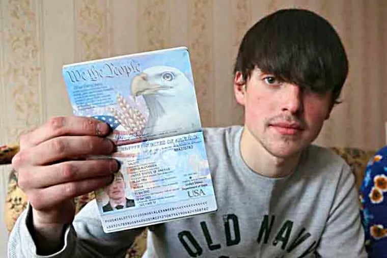 In this photo taken on Saturday, March 20, 2013, Alexander Abnosov shows his American passport to journalists in the Volga river city of Cheboksary, Russia. Abnosov was adopted by an American couple at age 12; he has returned to Russia claiming that his parents treated him badly, according to reports from Russian media with close ties to the Kremlin. (AP Photo / Nikolay Alexandrov)