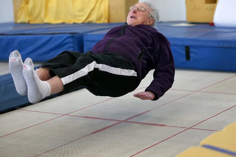 Elliott Royce takes trampoline lessons at Minnesota Twisters, Tuesday, Feb. 25, 2015 in Edina, Minn. Royce estimates that he has fallen down at least 14,000 times to teach people -- primarily seniors -- how to fall safely if they are undone by slippery sidewalks. (Elizabeth Flores/Minneapolis Star Tribune/TNS)