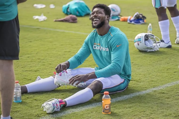 Dolphins cornerback Byron Maxwell shares a light moment with a teammate as he prepares for the combined practice with the Eagles on Monday.