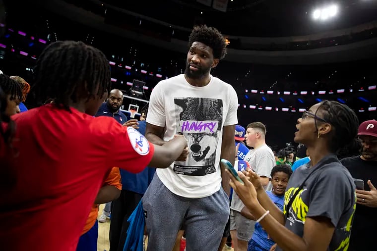 Joel Embiid greets kids during the "Merch Madness: Fan Gear Giveaway" hosted by Fanatics at the Wells Fargo Center on Tuesday, June 27.