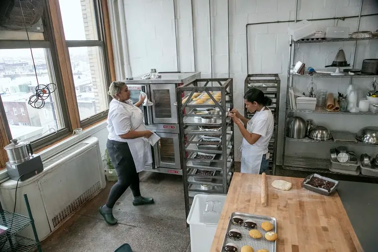 Rhonda Saltzman, left, and Mercedes Brooks check up on baked goods at their work space inside the BOK Building in South Philadelphia on Thursday, April 7, 2022. The sisters launched Second Daughter baking co. in 2020 and were recently named James Beard semifinalists for Outstanding Baker.