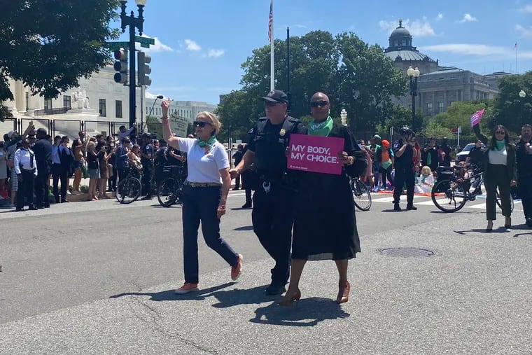 U.S. Rep. Madeleine Dean (D., Pa.), left, is arrested with other members of congress and abortion rights protesters in front of the U.S. Supreme Court on Tuesday in Washington, D.C.