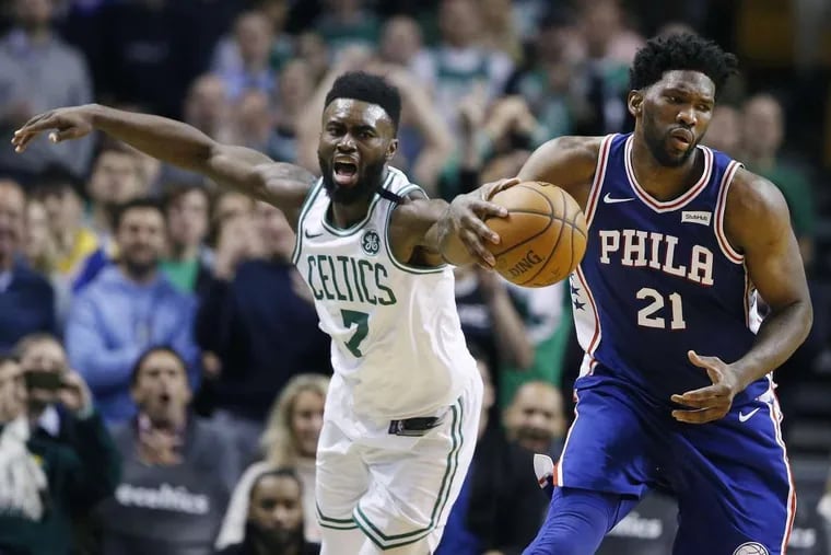 Sixers’ center Joel Embiid (right) beats Celtics’ guard Jaylen Brown to the ball during the fourth quarter of the Sixers’ 89-80 win on Thursday.