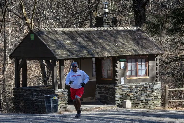 A runner jogs past a composting toilet on Forbidden Drive at the bridge at bottom of Kitchens Lane. The park gets millions of visitors but has only 15 permanent toilets.