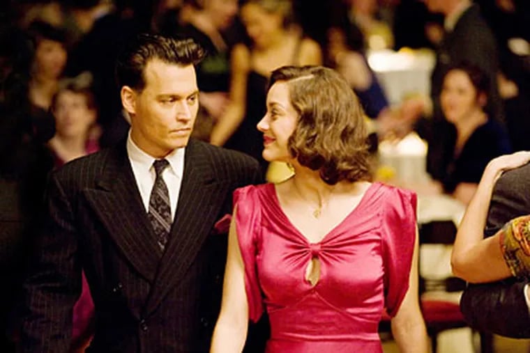 Johnny Depp stars and Marion Cotillard star in "Public Enemies."